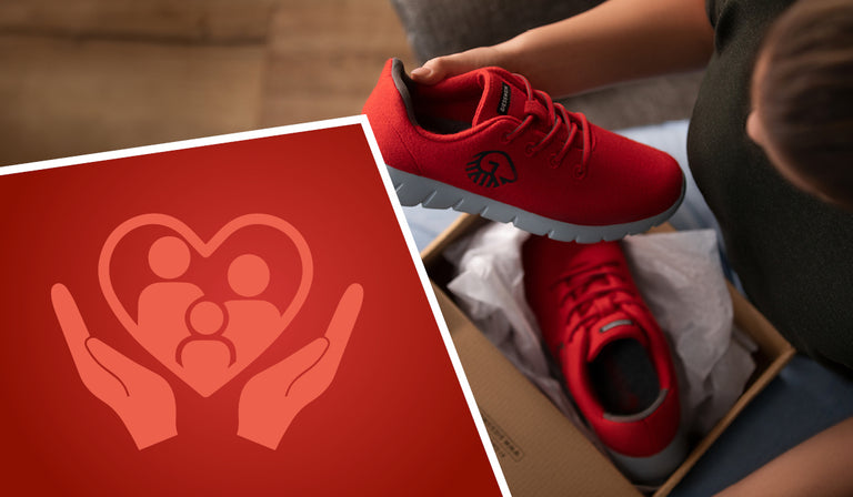 A person unboxes a pair of bright red GIESSWEIN sneakers, holding one shoe up for a closer look. The shoes have grey soles and the brand's black logo on the side. In the bottom left corner, a red graphic features two hands cradling a heart-shaped icon with three stylized figures representing a family, symbolizing care, comfort, or family support.